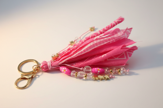 Hot pink fabric tassel keychain with gold star charms, pink polka dot beads, crystal beads and gold-tone lobster clasp hardware