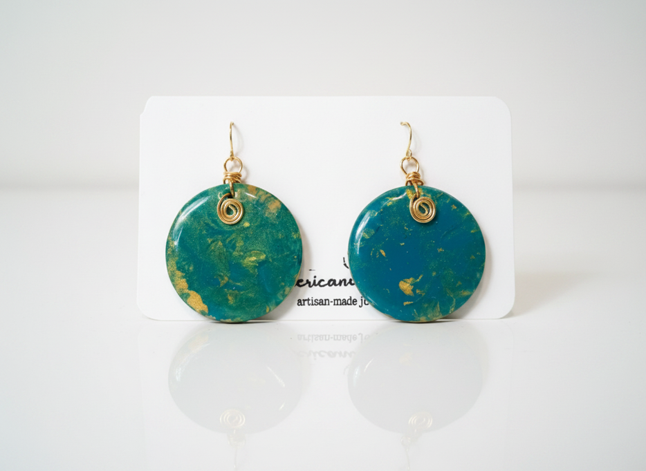 Handpainted teal and gold wood disc earrings with gold wire scroll on American Taina jewelry card