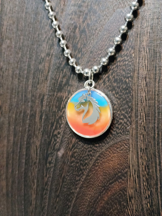 Sunset Spirit Horse Pendant Necklace on wood background - original photo