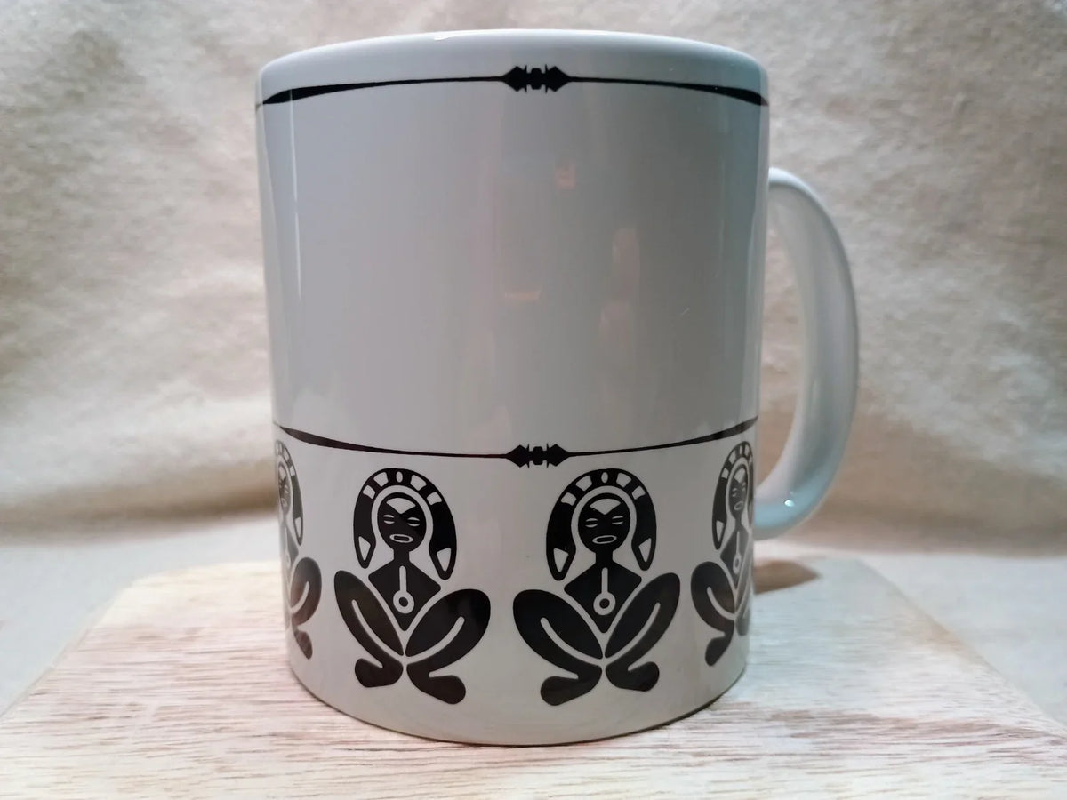 White ceramic mug with black Taino indigenous figure designs and decorative border