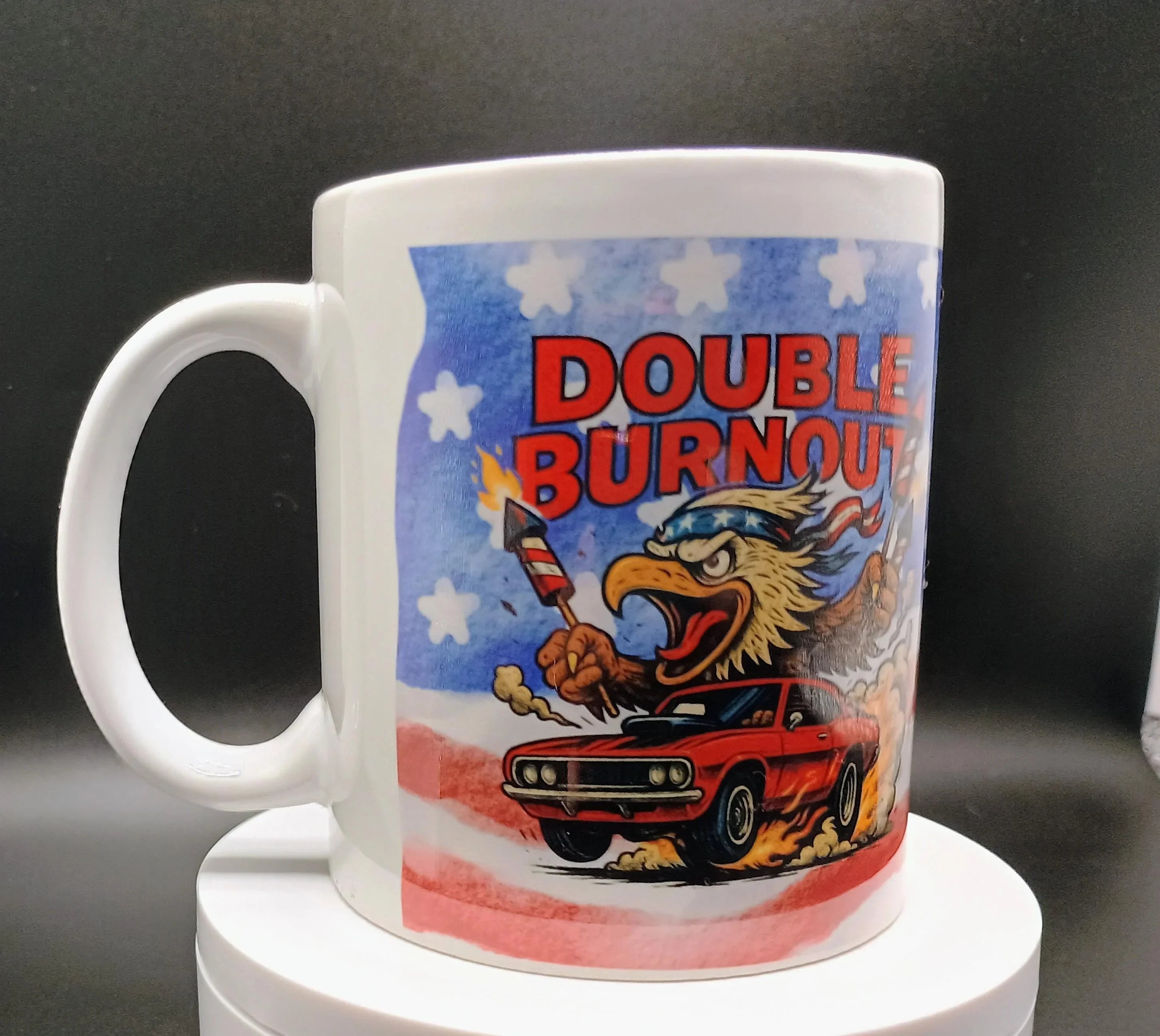 White mug with cartoon eagle holding rockets and red muscle car with text Double Burnout and American flag background