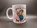 White coffee mug with vintage-style illustration of a woman cowboy holding gun and text 'Wanted and Wild'