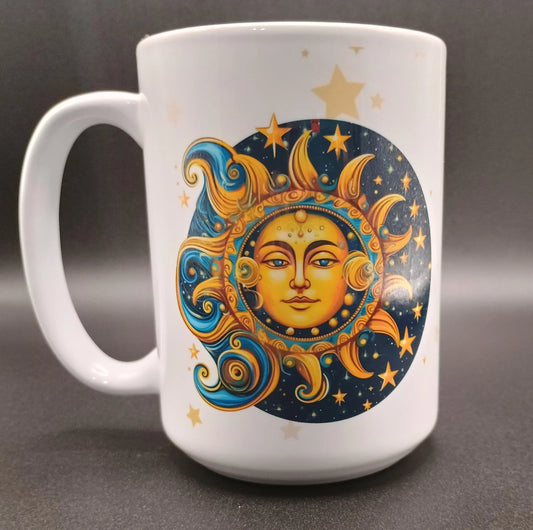 White ceramic mug with artistic sun and moon face design in blue and gold tones