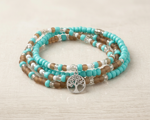 Three glass bead bracelets in turquoise, brown and clear tones with silver-tone accents and a tree charm