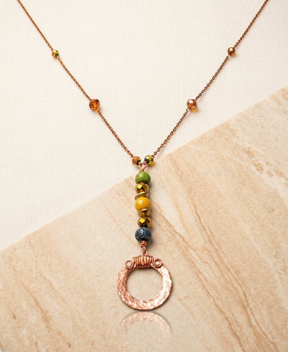 24-inch copper necklace with green, golden-yellow and deep blue ceramic and glass beads and a textured copper circle pendant