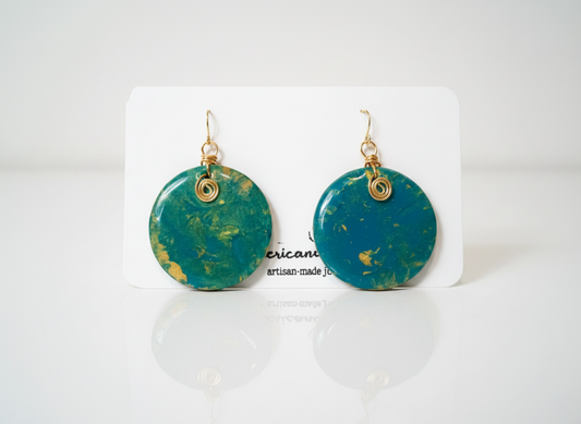 Handpainted teal and gold wood disc earrings with gold wire scroll on American Taina jewelry card