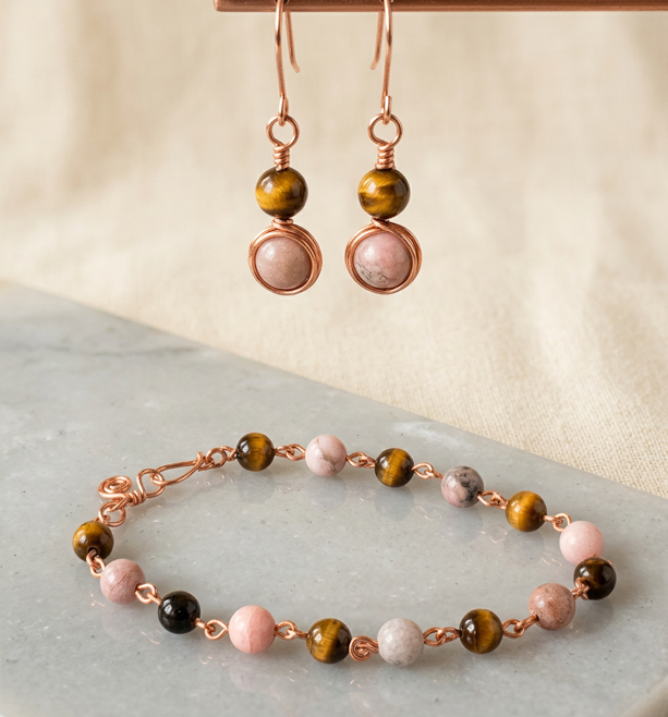 Pink zebra jasper and tiger eye bracelet and earring set on coated copper wire - styled product shot