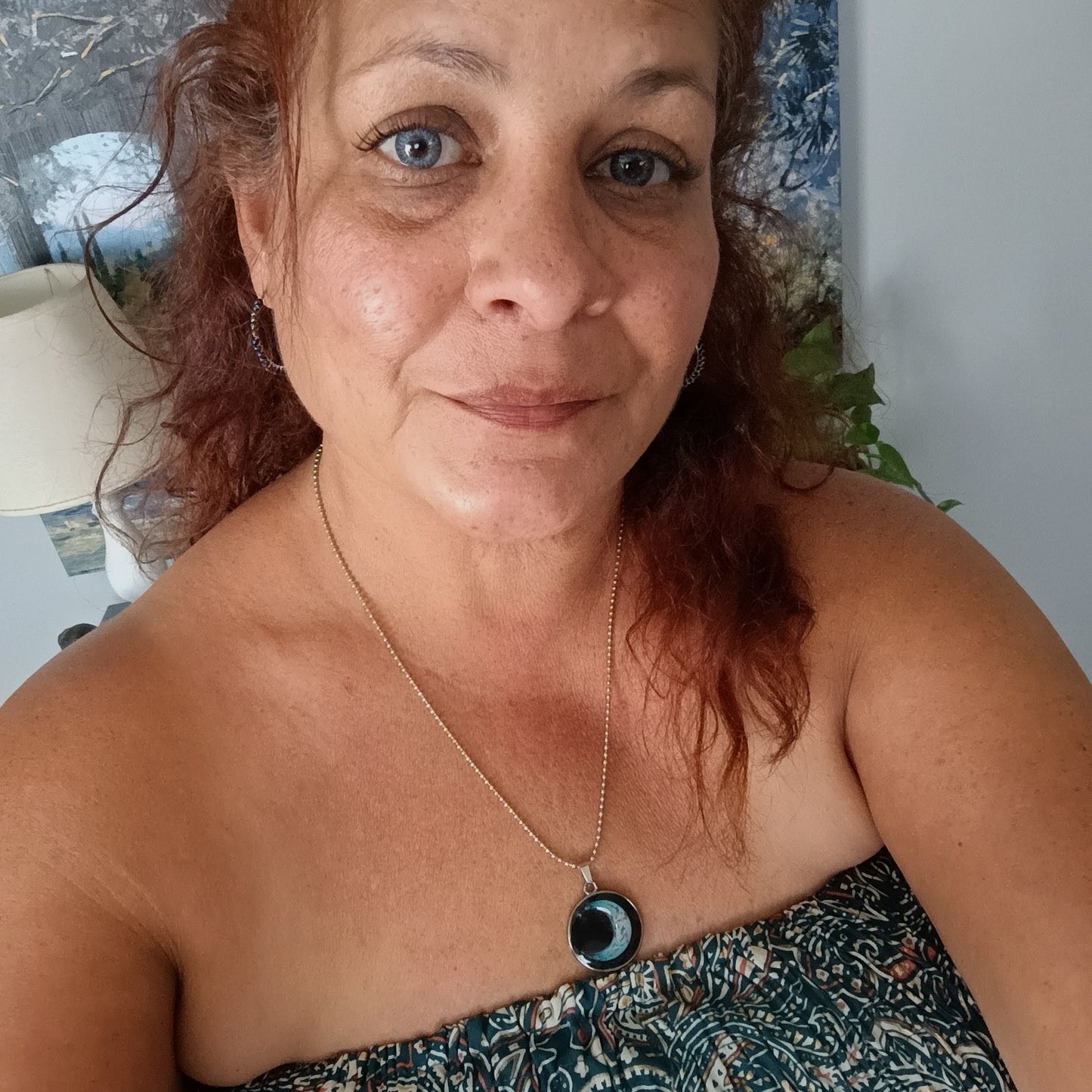 Maker wearing the Galaxy Teal crescent moon resin pendant necklace on a silver ball chain
