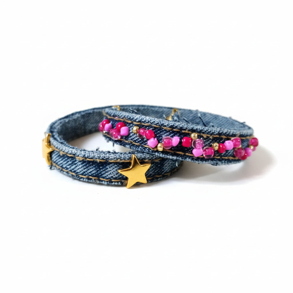 Denim bracelet with pink beads and gold stars on a light gray background