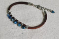 Bracelet with beads and leather strap on a textured surface