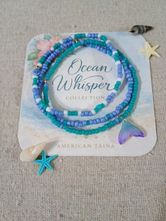 Set of beaded bracelets on a card labeled 'Ocean Whisper Collection' by American Taina, with starfish and shell decorations.