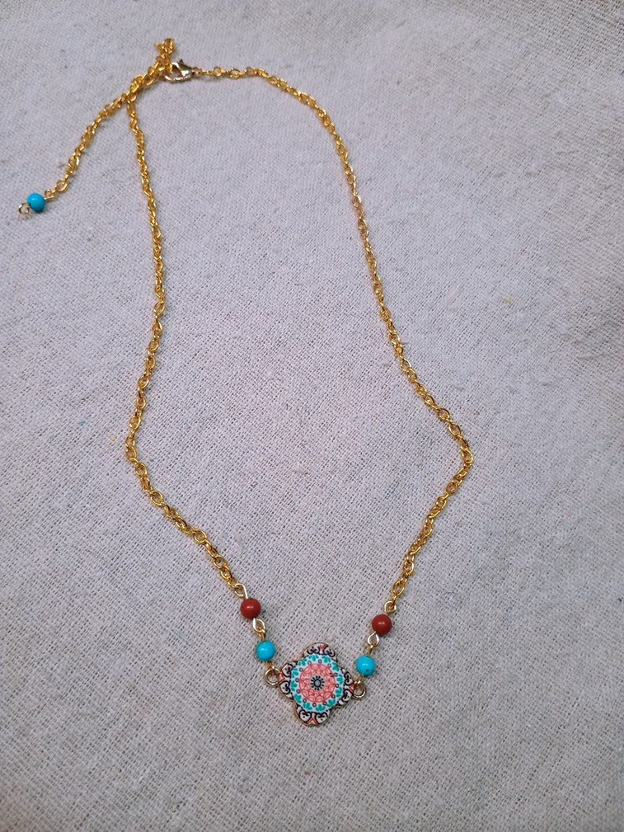 Necklace with a decorative pendant on a textured surface