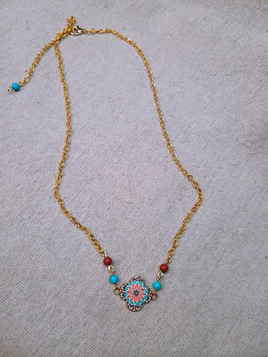 Necklace with a decorative pendant on a textured surface