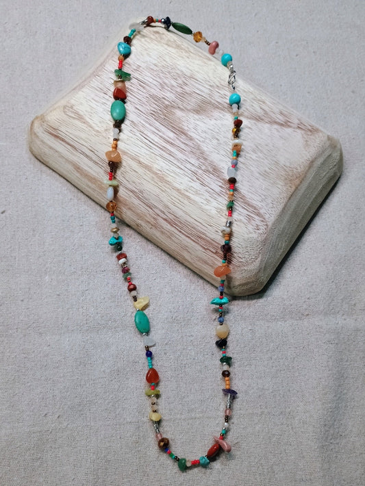 Beaded necklace on a wooden block with a neutral background