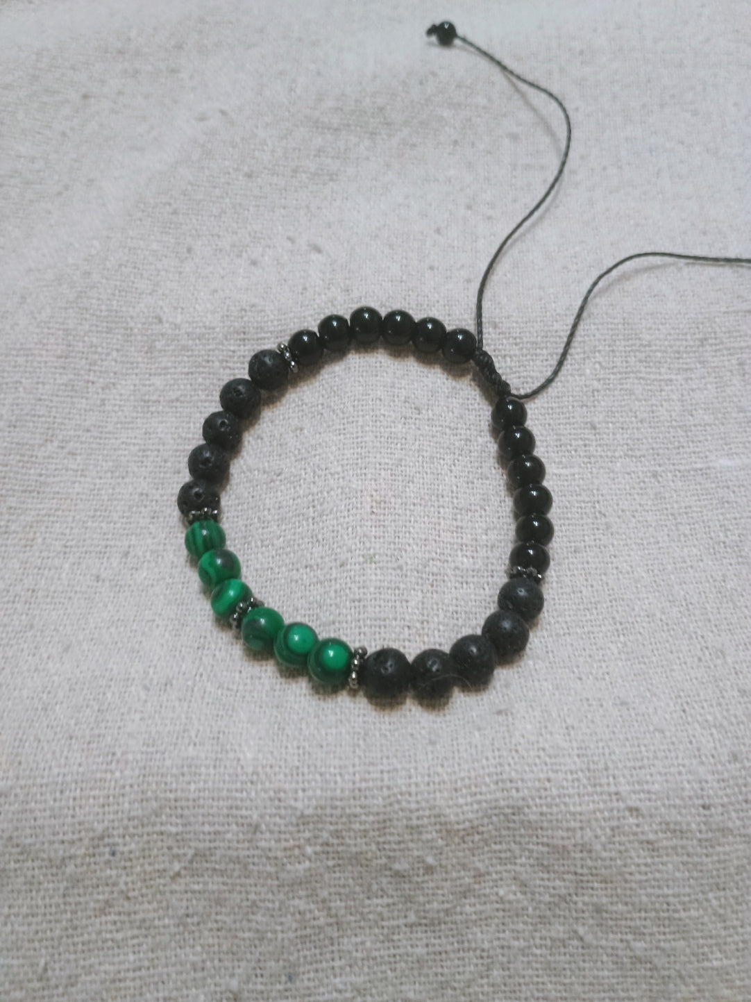 Handcrafted bracelet with black onyx, lava stone and malachite beads with silver hematite accents on black Brazilian wax cord