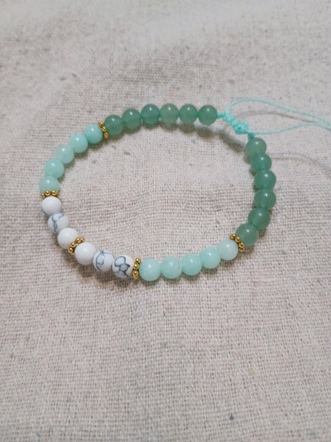 Handcrafted bracelet with amazonite, white turquoise and green aventurine beads with gold hematite accents on Brazilian wax cord
