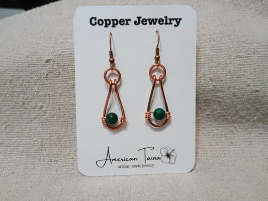 Copper teardrop earrings with wire-wrapped malachite bead on American Taina jewelry card