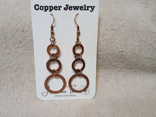 Copper triple ring dangle earrings on American Taina jewelry card