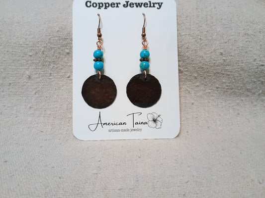 Copper disc earrings with turquoise and black seed beads on American Taina jewelry card