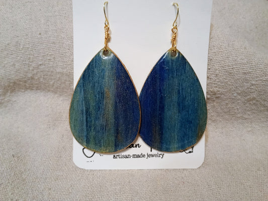 Handpainted blue ombré wood teardrop earrings with gold shimmer on American Taina jewelry card
