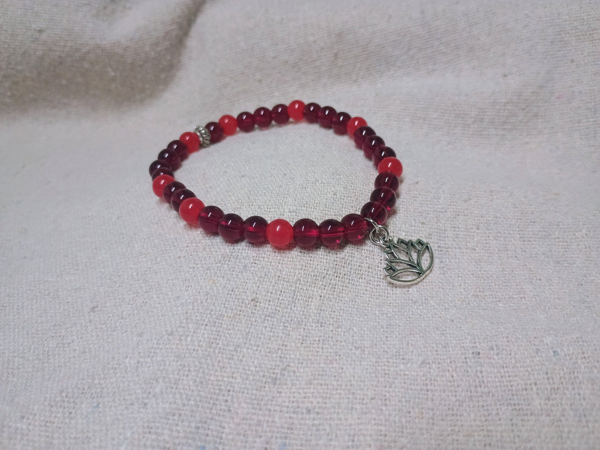 Burgundy and red beaded bracelet with silver-tone lotus flower charm