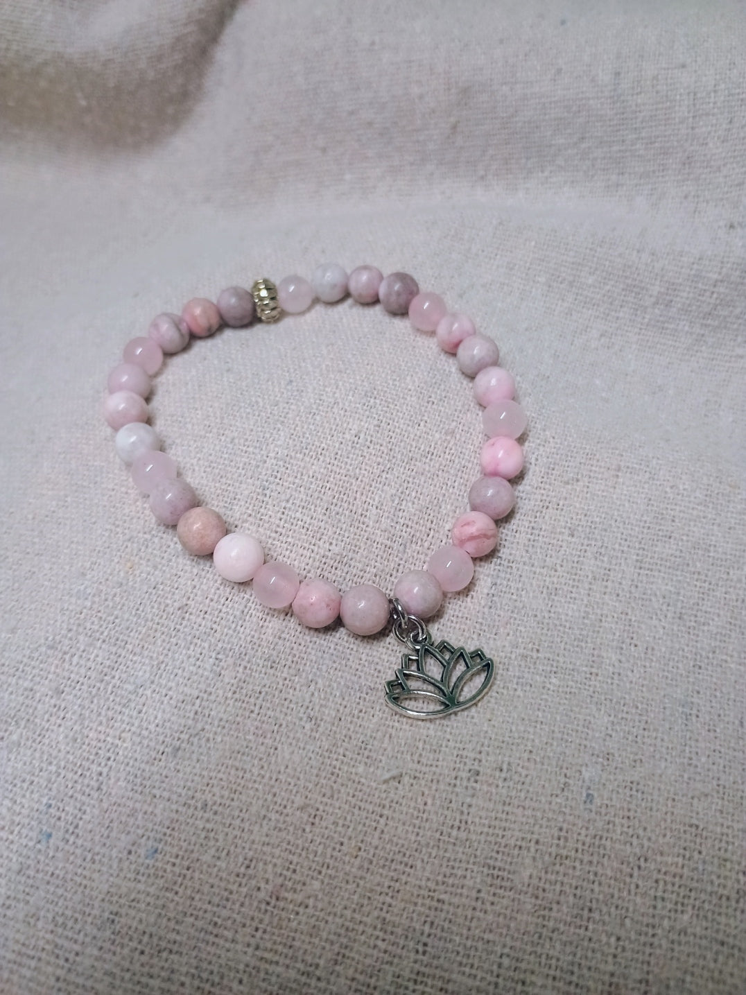 Soft pink beaded bracelet with silver-tone lotus flower charm