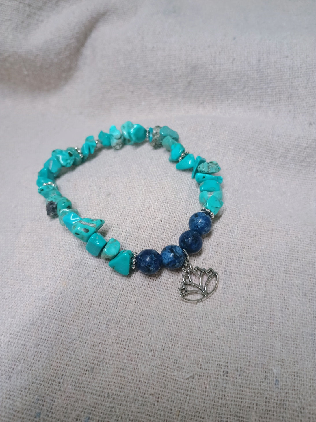 Turquoise-colored chip and navy bead bracelet with lotus flower charm