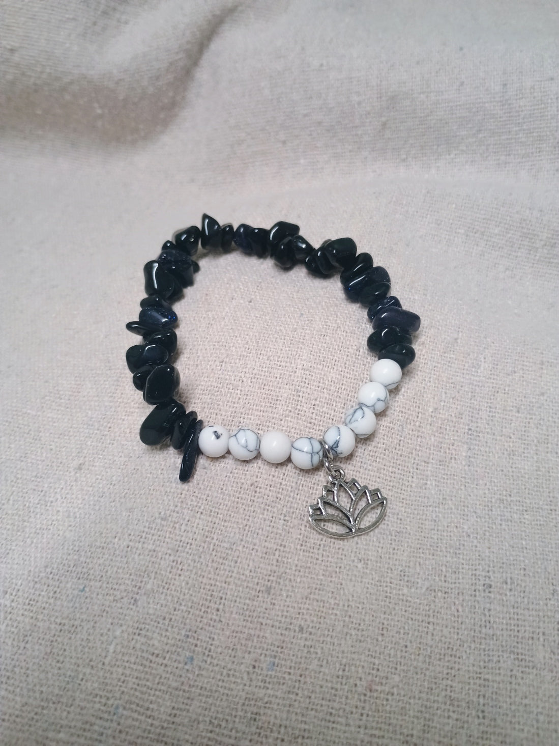 Black chip and white bead bracelet with lotus flower charm