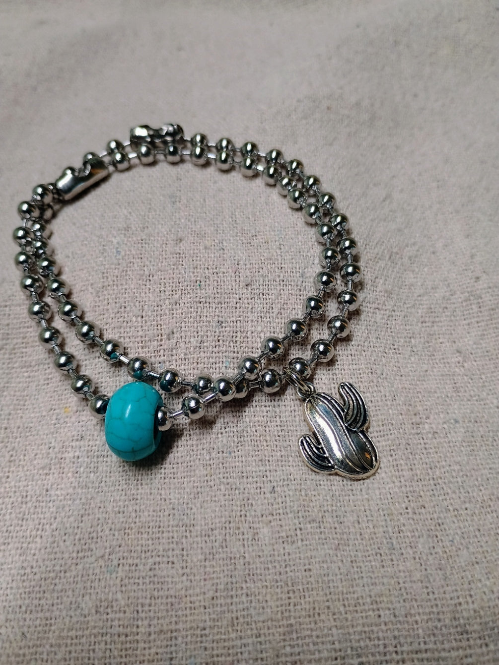 Silver-tone 4 mm ball-chain bracelet set with a turquoise-colored bead and cactus charm