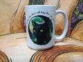 White ceramic mug featuring a black cat illustration with green eyes and a glowing full moon background
