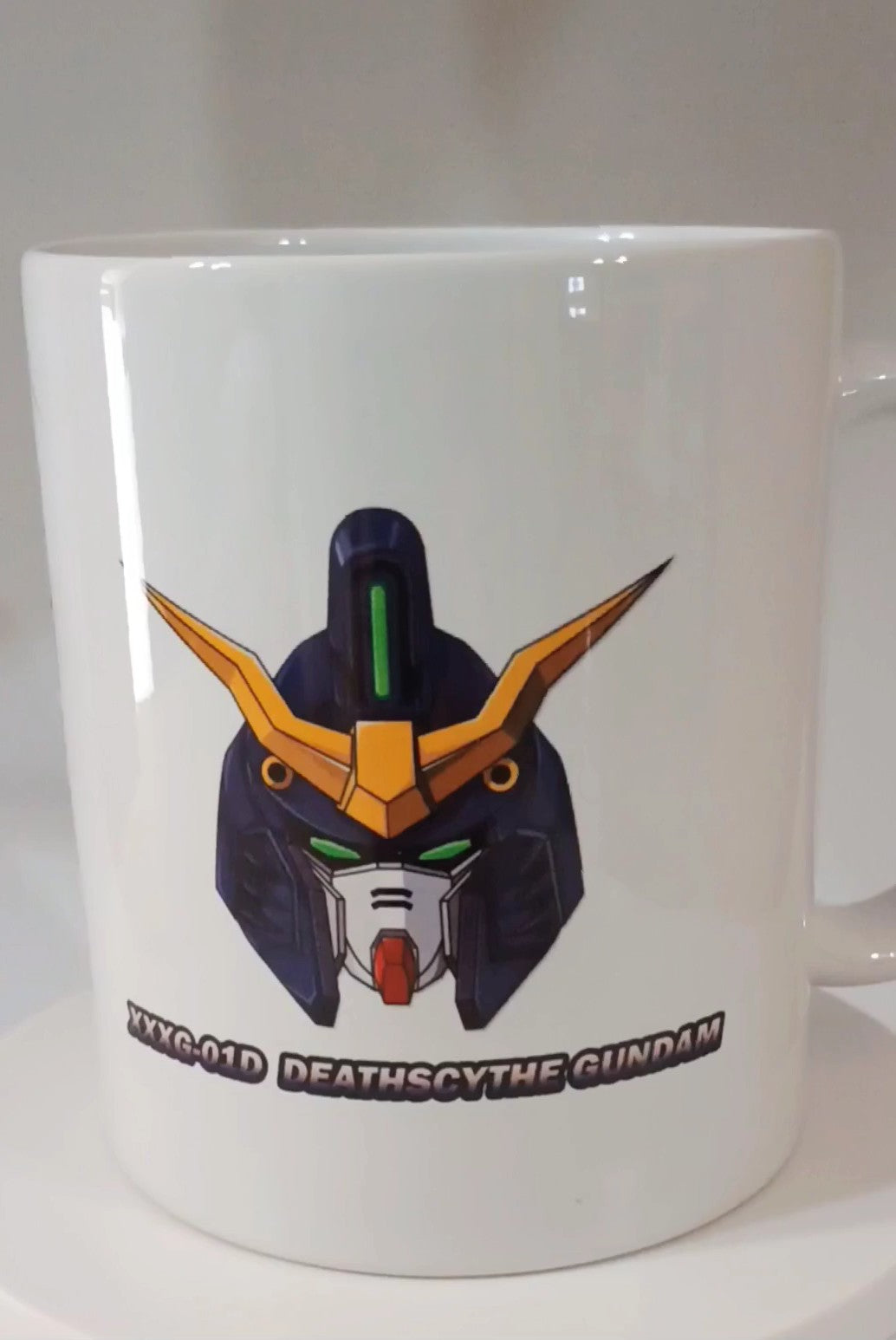White ceramic mug featuring a colorful Deathscythe Gundam robot head illustration and text