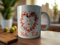 White mug with cute ghost inside fall leaf wreath and text Hello Fall on wooden table