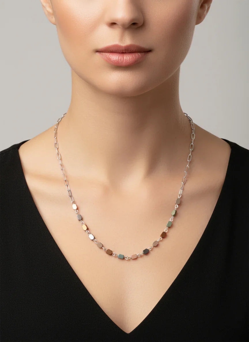 Hematite paperclip chain necklace with multicolor hexagonal beads worn on neck
