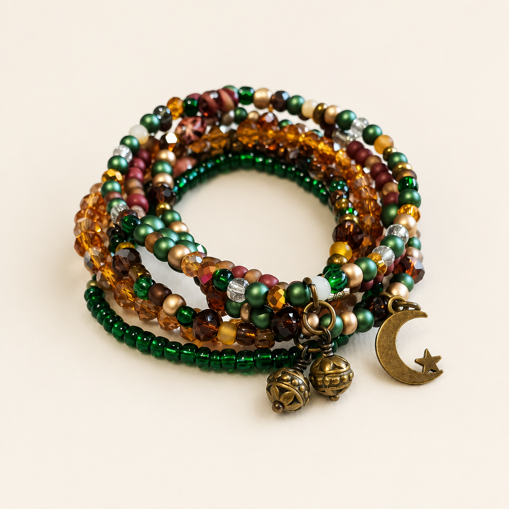 Studio-style image of green and amber bracelet stack with brass-colored moon and round charms
