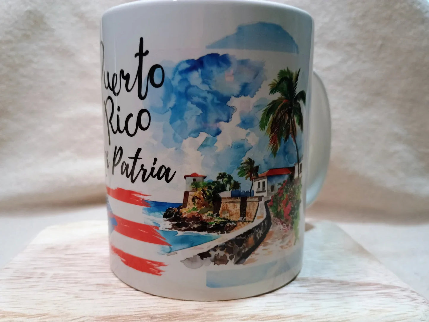 Puerto Rico souvenir mug with watercolor coastline, palm trees, and Spanish text 'Puerto Rico mi Patria'