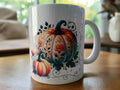White ceramic mug with orange and white pumpkins decorated with floral patterns on wooden table
