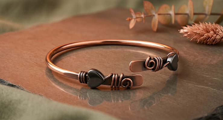 Oxidized copper open cuff bracelet with dark heart-shaped hematite accents