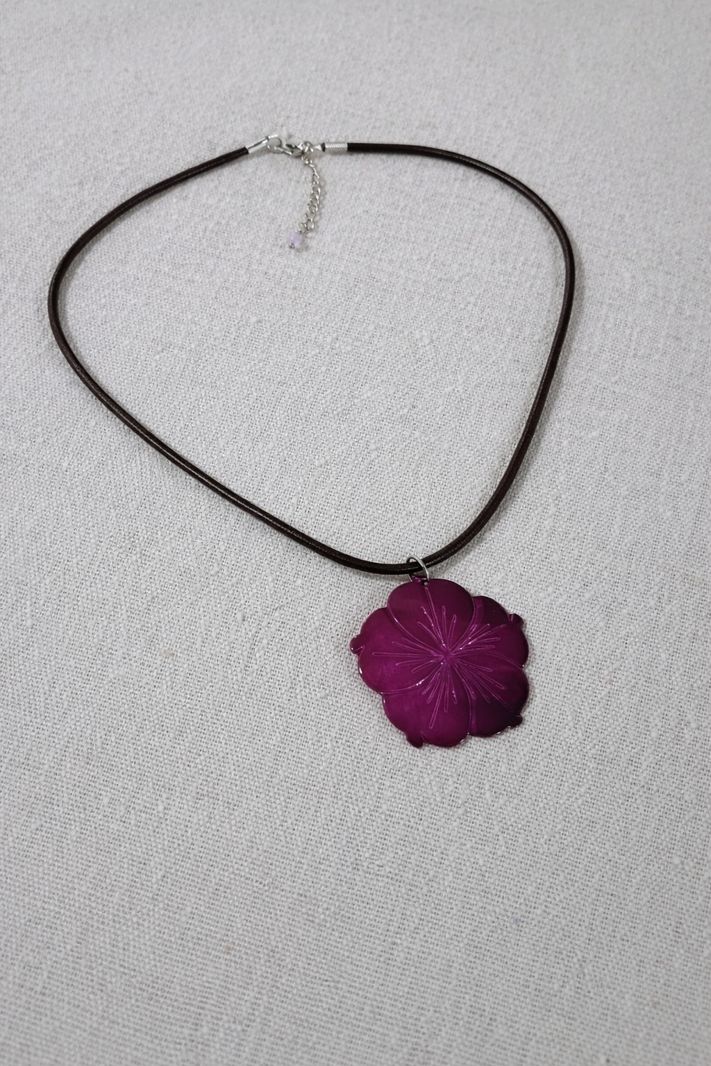 Necklace with a purple flower pendant 