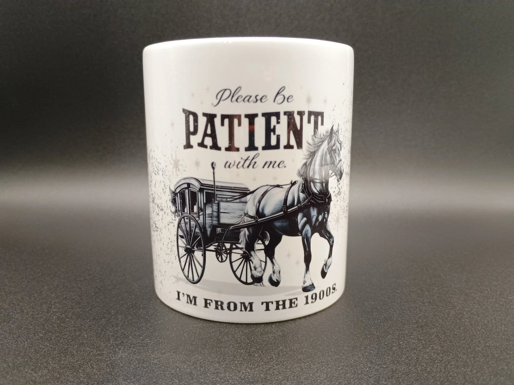 White ceramic mug with vintage horse and carriage graphic and text about being from the 1900s