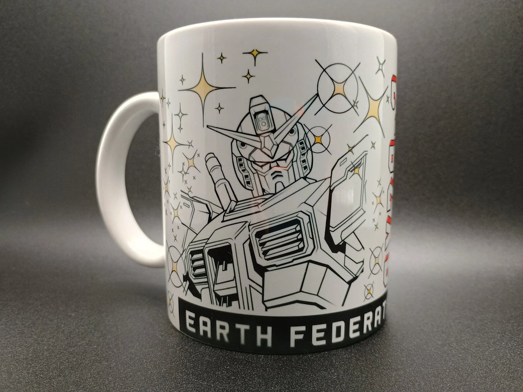 White ceramic mug featuring a detailed Gundam robot illustration with sparkling stars and text Earth Federation